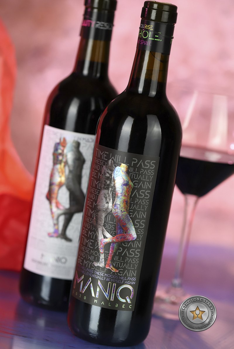 MANIQ wine label with expressive contrasting artwork and a neck label carrying an affirmation and NAMI reference